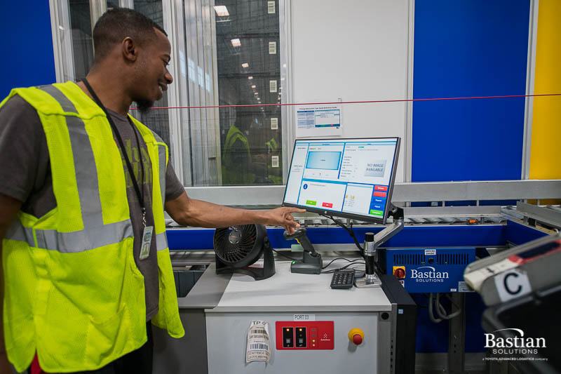 warehouse employee using AutoStore workstation computer